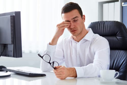 Man Rubbing His Eyes